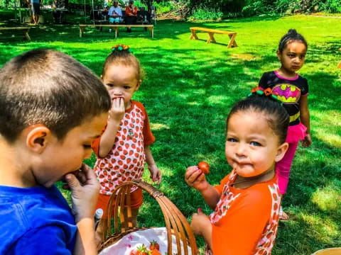 a group of children eating fruit