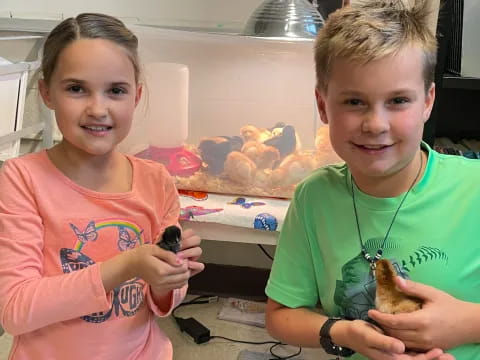 a couple of kids holding cookies