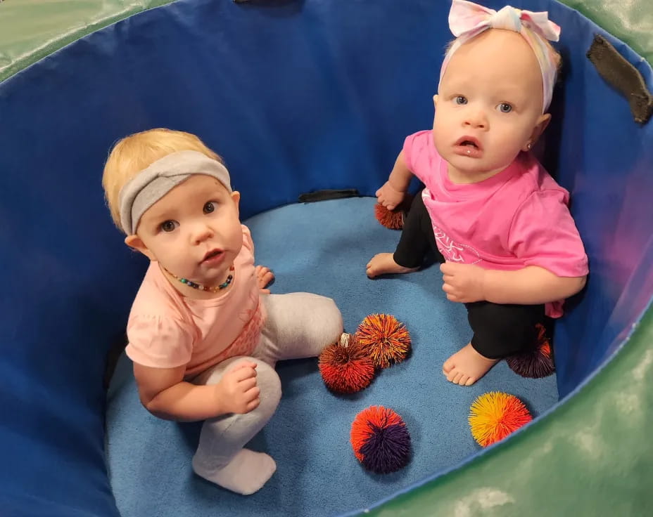 two babies on a mat