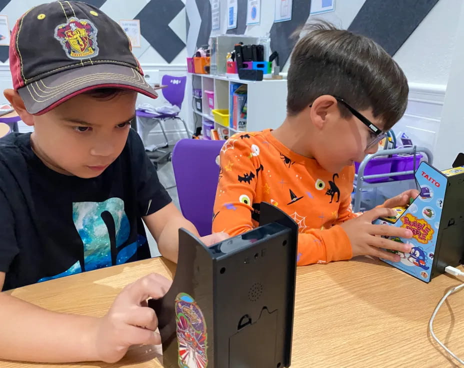 a couple of boys playing with a box