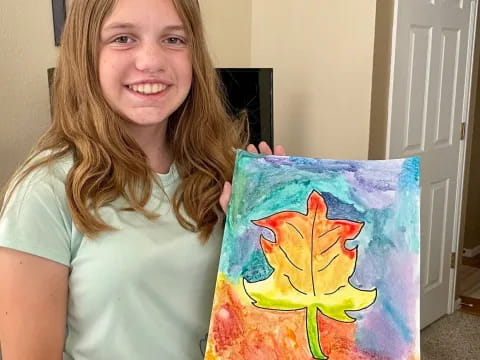 a woman holding a drawing