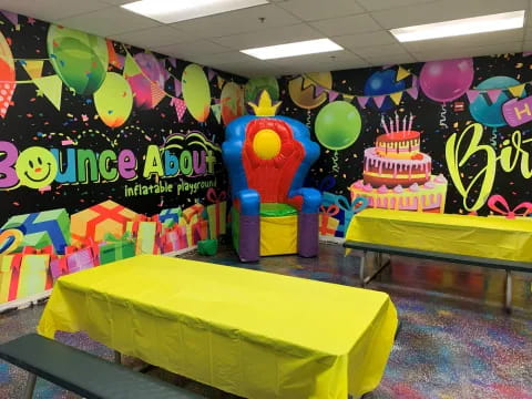 a room with a table and balloons