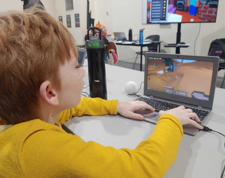 a young boy using a laptop