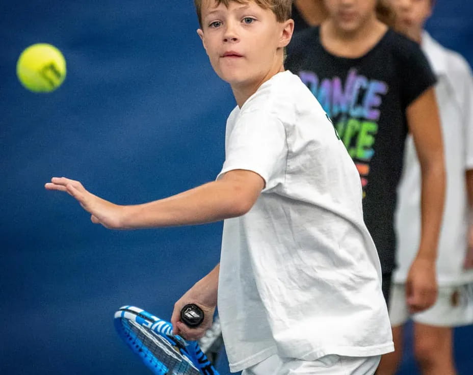a boy playing tennis