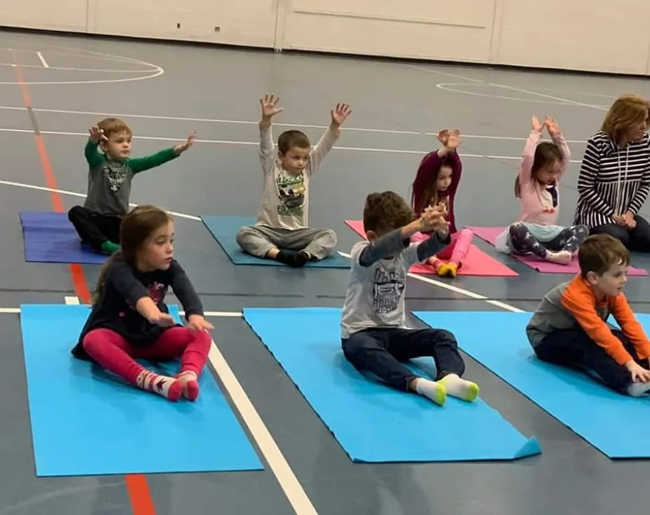 a group of children sitting on mats