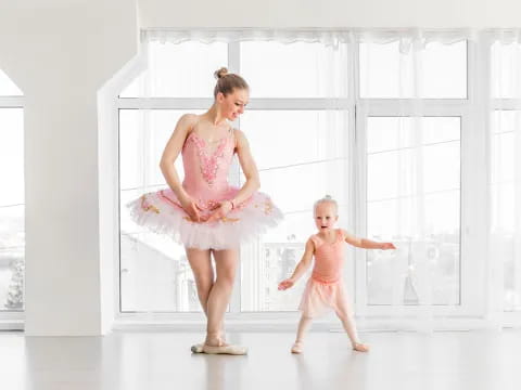 a woman and a baby dancing