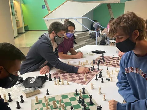 a group of people playing chess