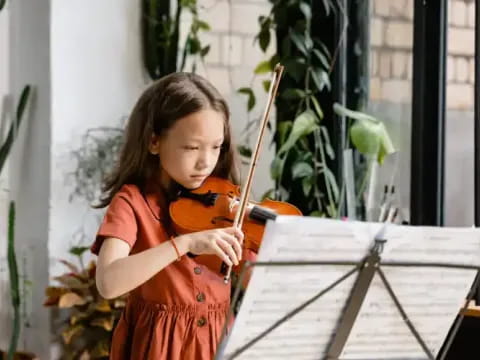 a girl playing a violin
