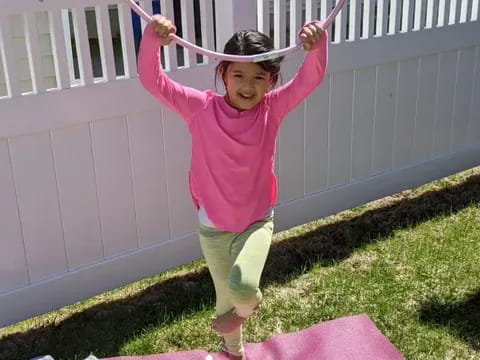a girl jumping on a trampoline
