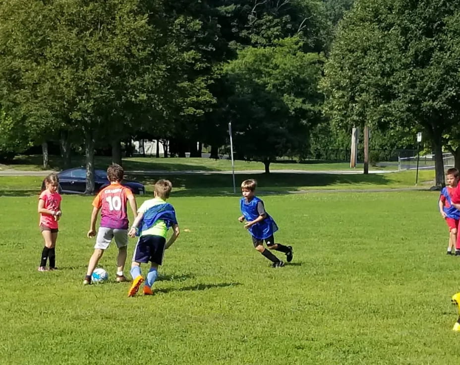 a group of kids playing football
