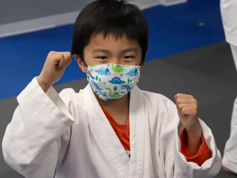 a boy holding a drawing