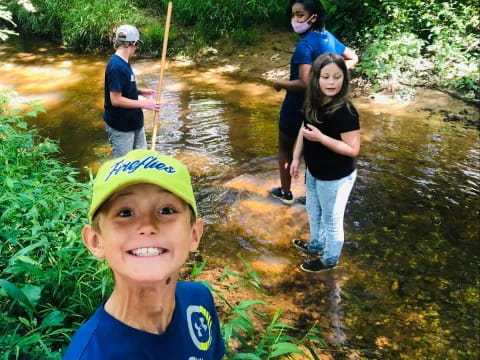 a group of people standing in a stream