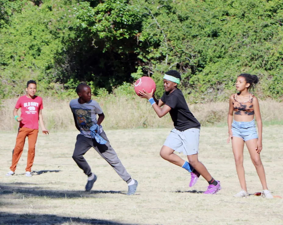 a group of people playing frisbee