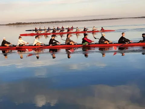 a group of people rowing a boat