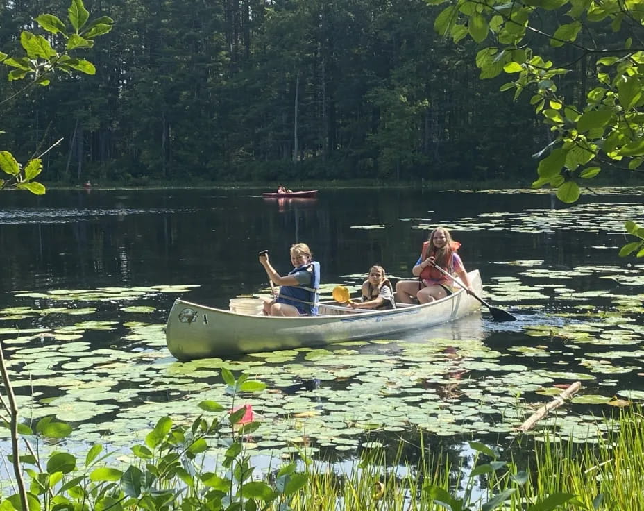 a group of people in a canoe on a lake