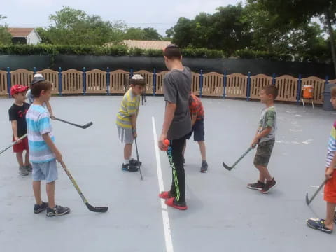 a group of people holding brooms