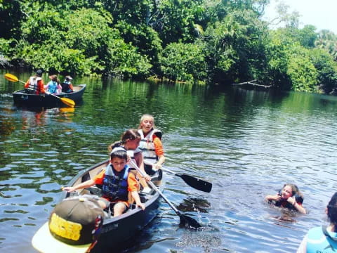 a group of people in a canoe