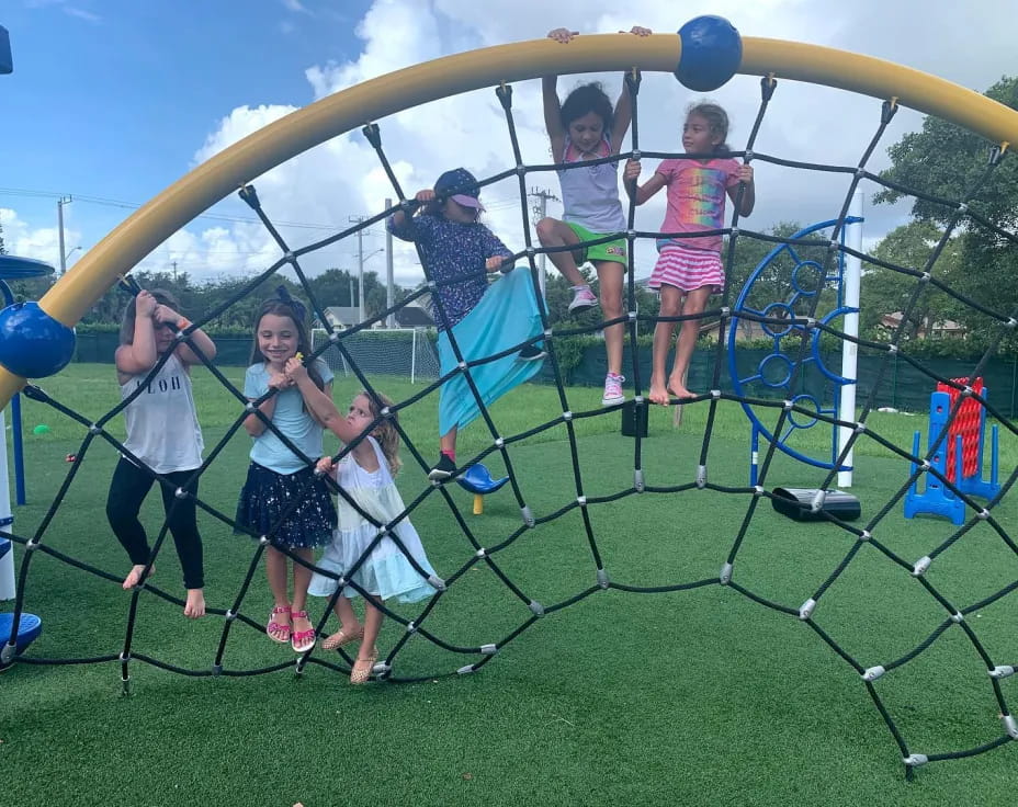 a group of people on a swing set