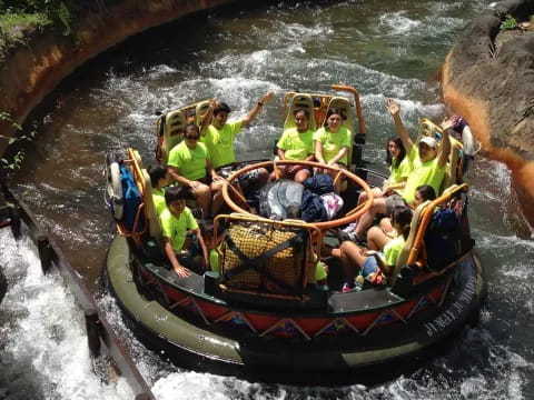 a group of people ride in a boat down a river