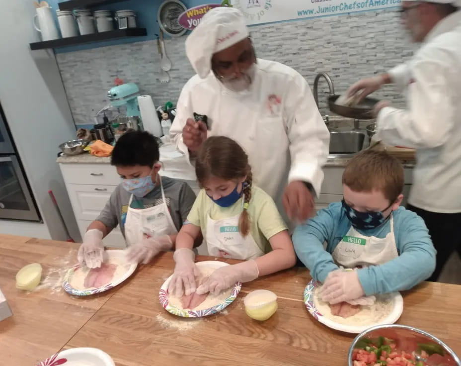 a group of kids making food