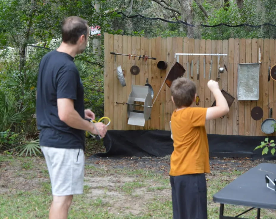 a man and a boy playing with a toy