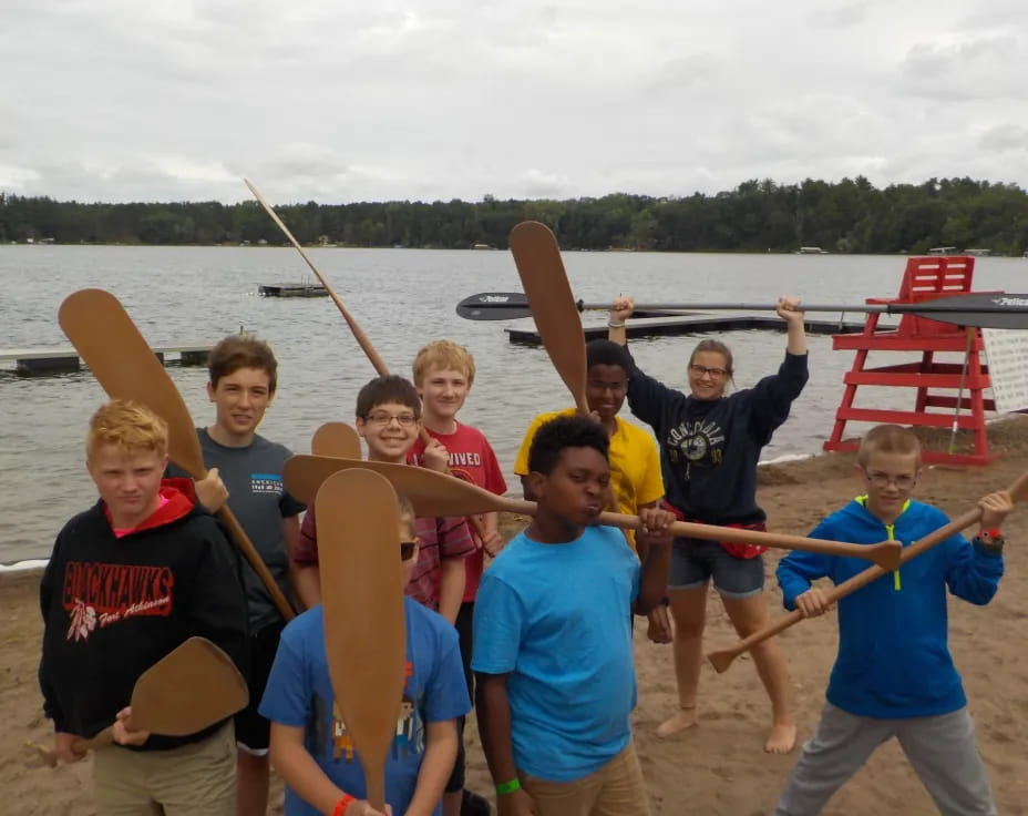 a group of people holding paddles