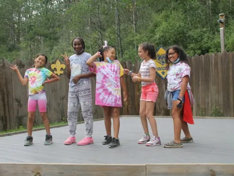 a group of kids holding signs