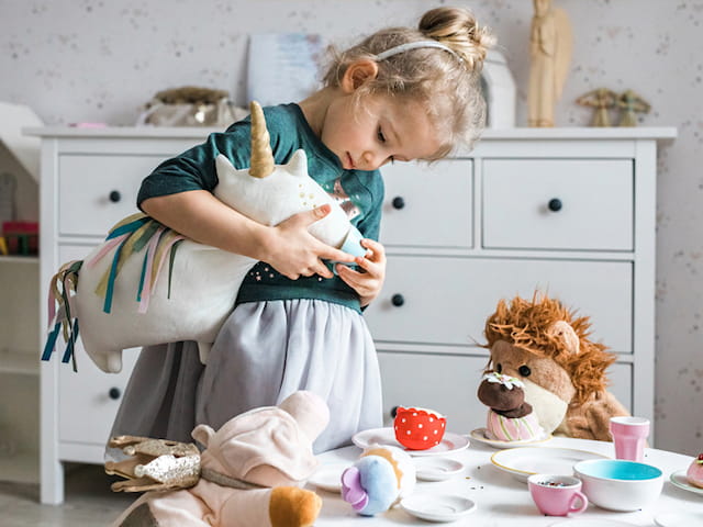 a girl in a hospital bed holding a rabbit