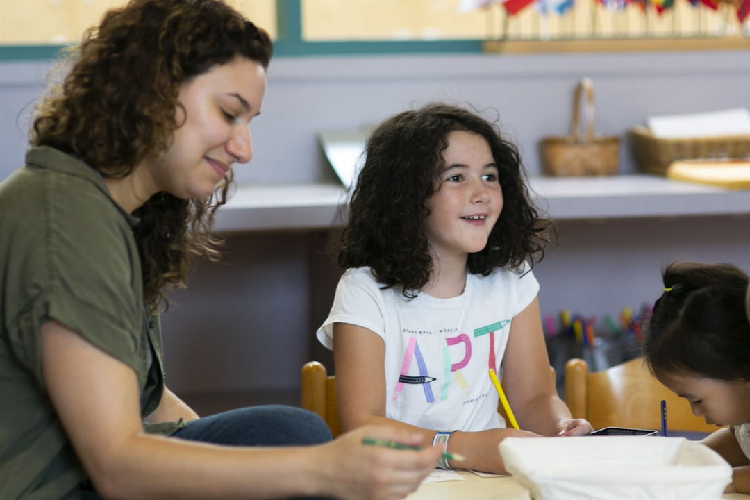 a person and a child sitting at a table