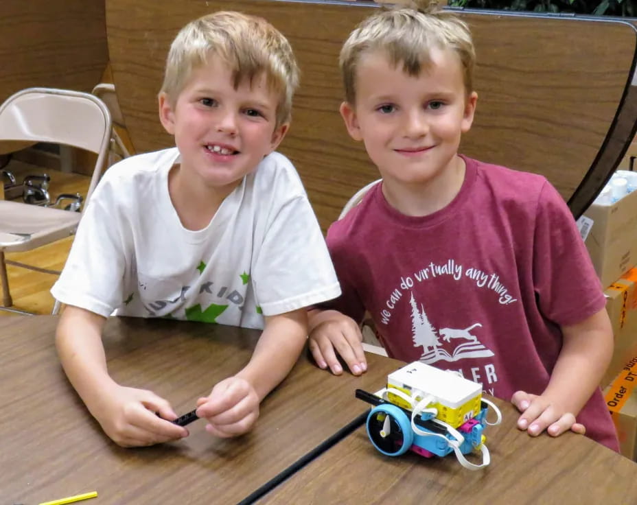 two boys sitting at a table