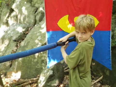 a boy holding a blue umbrella