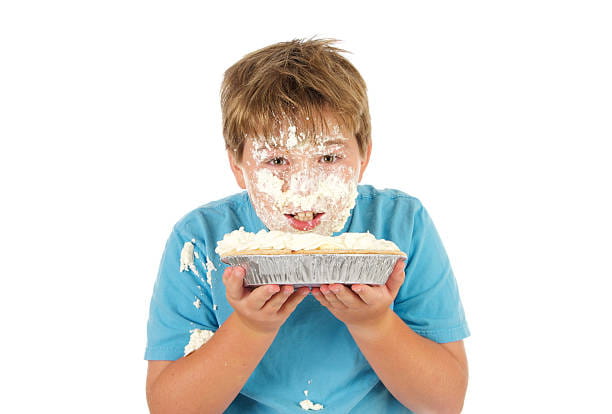 a boy holding a cake