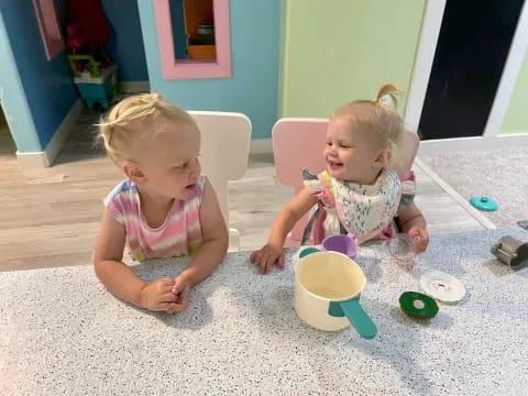 two children sitting on the floor