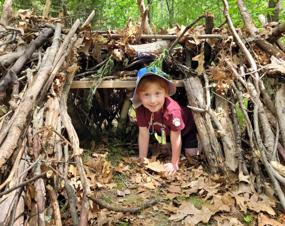 a child in a pile of sticks