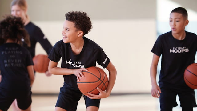 a group of boys playing basketball
