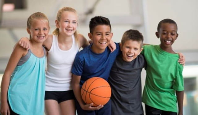 a group of kids holding a basketball