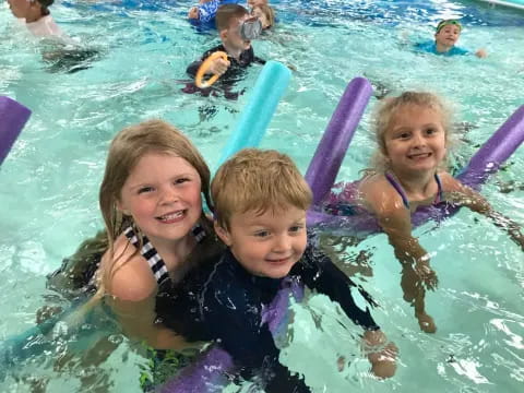 a group of children in a pool
