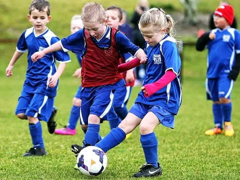 kids playing football on a field