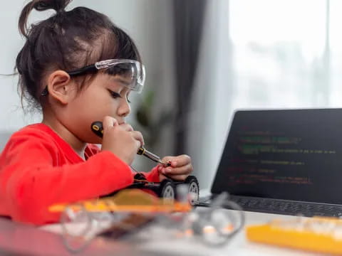 a young girl using a microscope