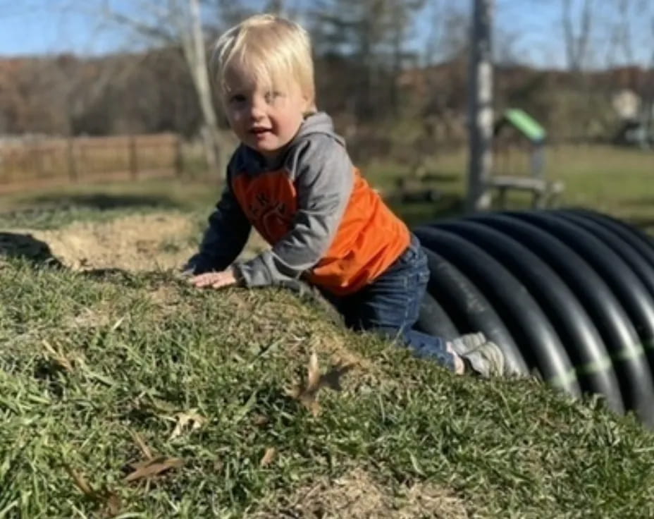 a child playing in the grass