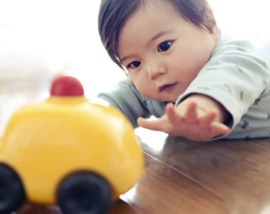 a baby playing with a toy