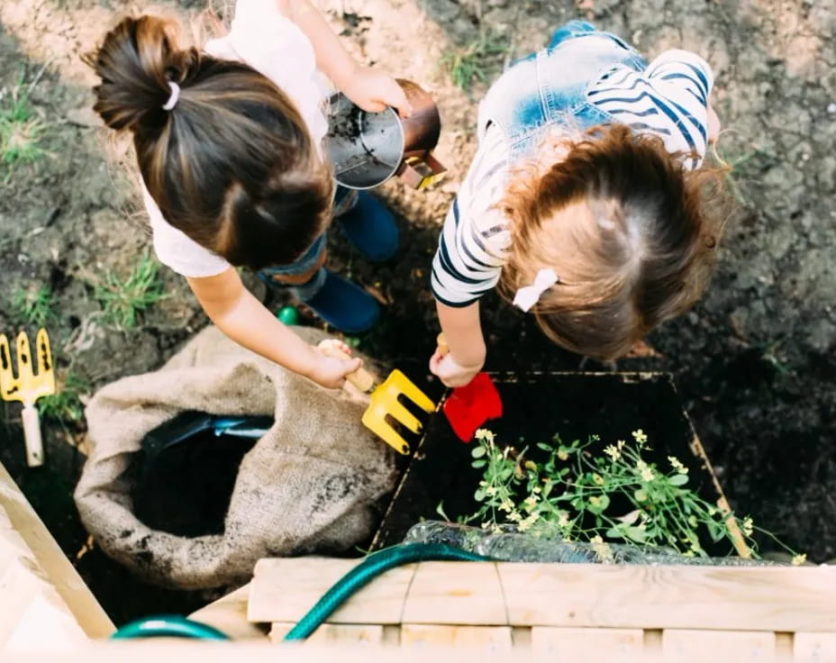 a couple of girls planting plants
