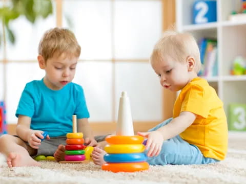 two boys playing with sand