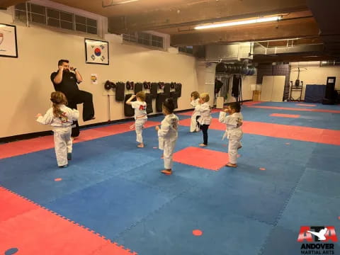 a group of kids in karate uniforms