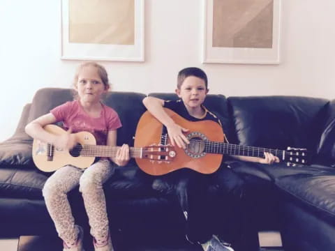 a man and a woman holding guitars