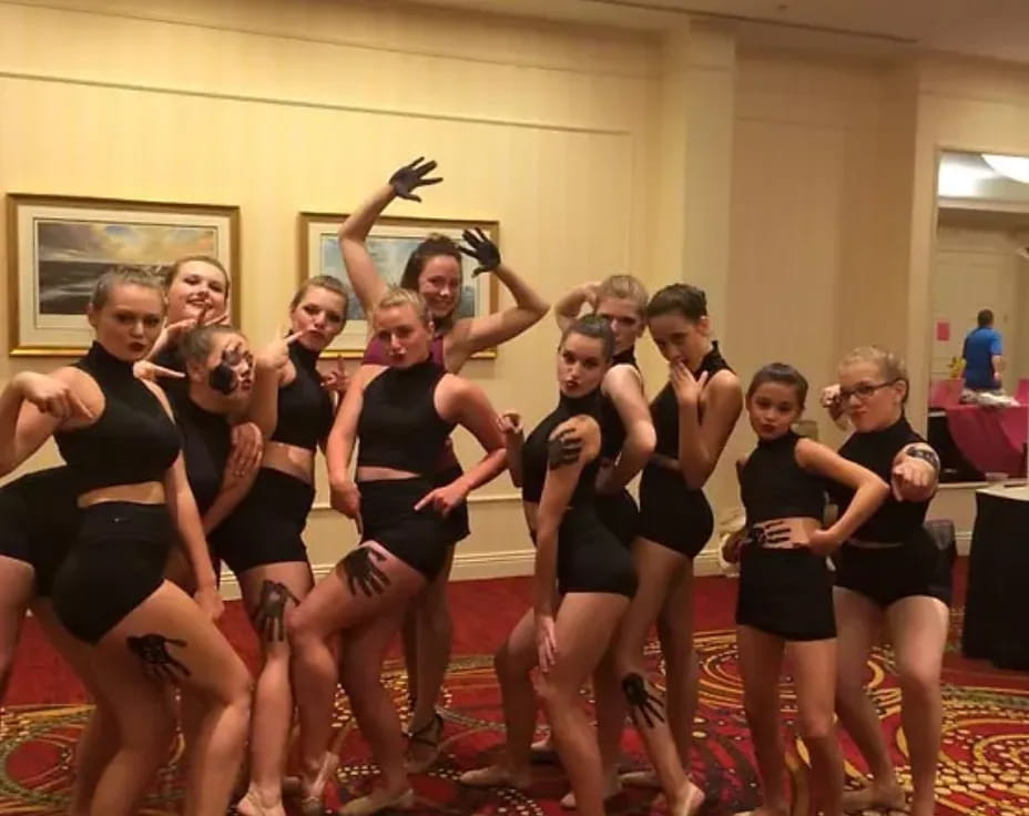 a group of women in black dancing