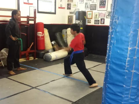 a boy kicking a blue rope