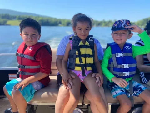 a group of boys sitting on a boat