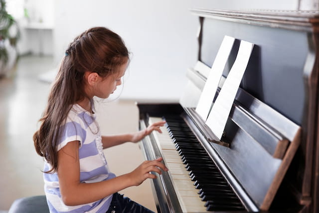 a girl playing a piano