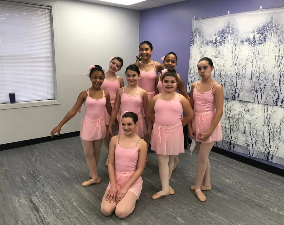 a group of women in pink dresses